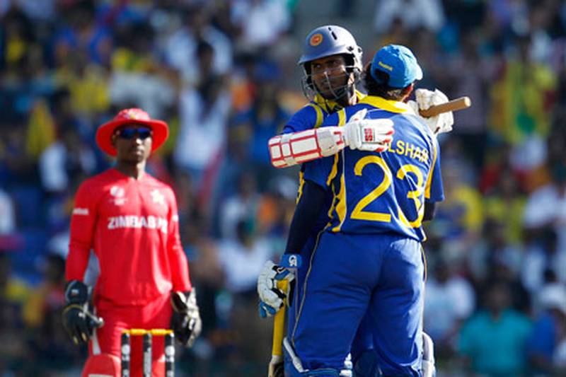 Upul Tharanga, centre, and Tillakaratne Dilshan embrace during their stand.