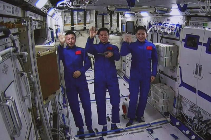 Chinese astronauts from left, Cai Xuzhe, Chen Dong and Liu Yang wave from inside the Wentian lab module on Monday, July 25, 2022.  China added the laboratory to its permanent orbiting space station Monday as it moves toward completing the structure in coming months.  Photo:  Xinhua News Agency