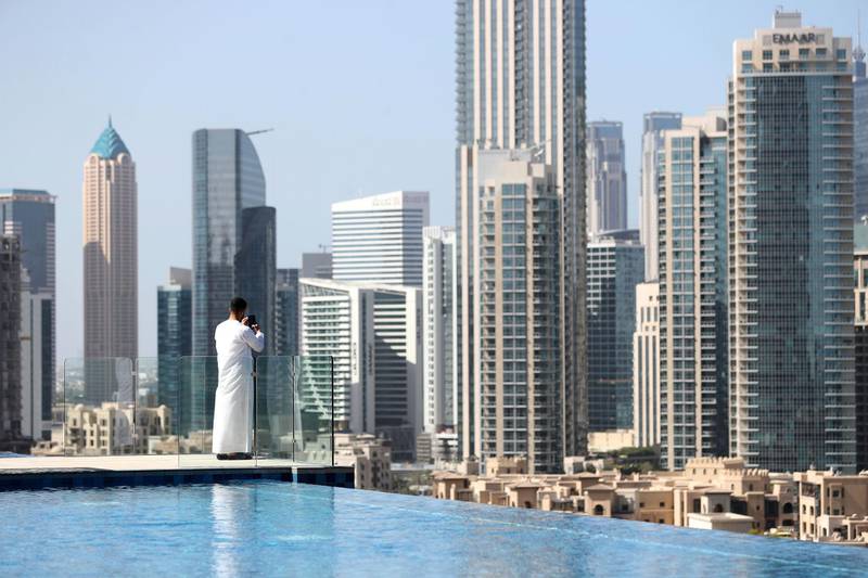 Dubai, United Arab Emirates - Reporter: N/A: A visitor to the Address Fountain Views Hotel takes pictures of Downtown Dubai. Tuesday, 3rd of March, 2020. Downtown, Dubai. Chris Whiteoak / The National