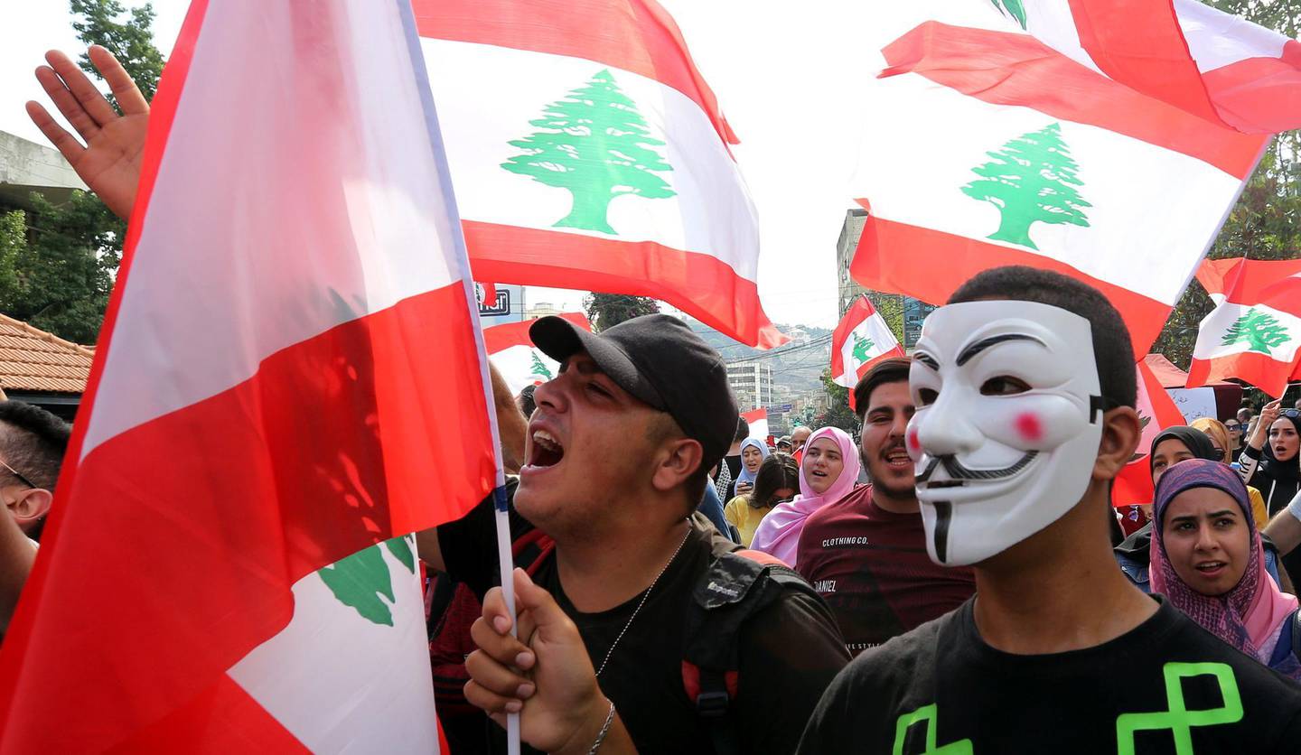 A demonstrator wears a Guy Fawkes mask during an anti-government protest in the southern city of Nabatiyeh, Lebanon October 20, 2019. REUTERS/Aziz Taher