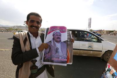 epa06153254 A Yemeni man holds posters depicting former president Ali Abdullah Saleh ahead of an anniversary celebration of Saleh’s party, General People's Congress, in Sana’a, Yemen, 20 August 2017. According to reports, the Houthi rebels have accused Yemen’s ex-president Ali Saleh and his party, General People’s Congress, (GPC) of exerting political extortion and following policies that support the Saudi-led military coalition fighting the Houthi rebels for more than two years.  EPA/YAHYA ARHAB