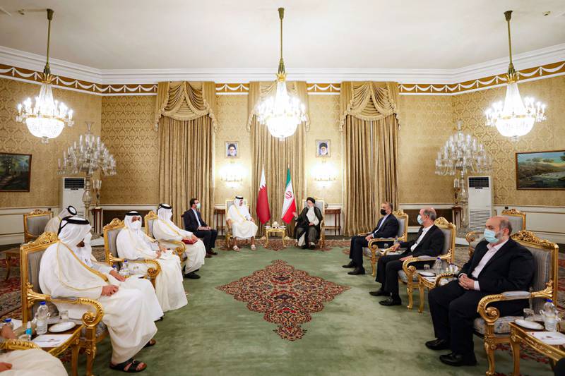 Iran's President Ebrahim Raisi speaks with Qatari Emir Sheikh Tamim bin Hamad Al Thani in Tehran. Reuters