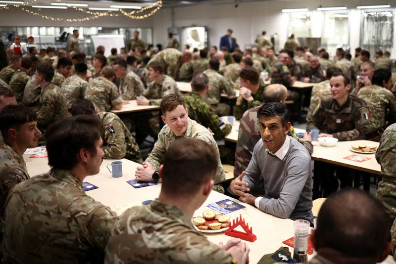 British Prime Minister Rishi Sunak eats Christmas dinner with troops at the Tapa military base in Estonia. Reuters