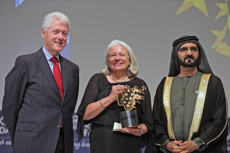 Nancie Atwell, a teacher from Southport, Maine, US, receives the 2015 Global Teacher Prize from Sheikh Mohammed bin Rashid, Vice President and Ruler of Dubai, and former US President Bill Clinton in Dubai. Atwell has been teaching since 1973 and founded the Centre for Teaching and Learning in Southport. Kamran Jebreili / AP