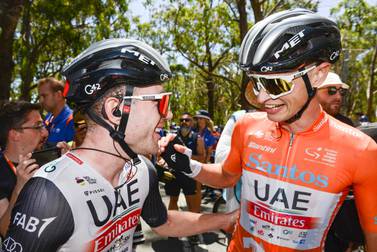 Swiss rider Marc Hirschi from UAE Team Emirates (L) congratulates teammate Australian Jay Vine for winning the Tour Down Under UCI cycling event in Adelaide on January 22, 2023.  (Photo by Brenton EDWARDS  /  AFP)  /  -- IMAGE RESTRICTED TO EDITORIAL USE - STRICTLY NO COMMERCIAL USE --