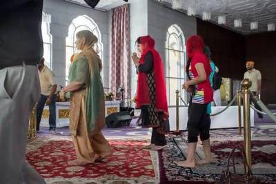 Baljinder Kaur, centre, always takes her family and visiting friends to see the region's only gurdwara in Jebel Ali. Antonie Robertson / The National