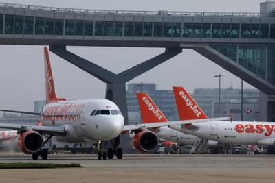 A passenger aircraft operated by EasyJet Plc taxis past other aircraft at London Gatwick airport in Crawley, U.K., on Wednesday, Sept. 27, 2017. EasyJet��revealed that it's working with U.S. startup��Wright Electric to develop a battery-powered plane.��Photographer: Luke MacGregor/Bloomberg