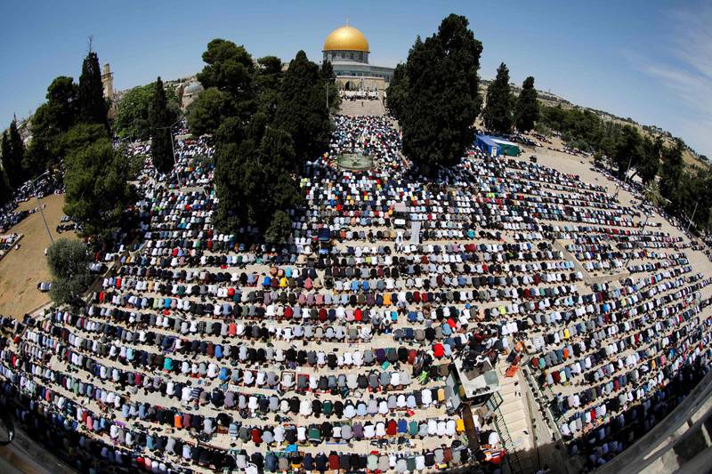 Palestinian worshippers gather to pray outside the Dome of the Rock shrine in the Al Aqsa Mosque compound for the final Friday of the holy month. AFP