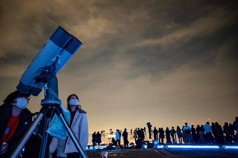 Stargazers on the observation deck at Roppongi Hills in Tokyo on November 19, 2021 to watch the lunar eclipse. AFP