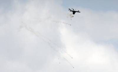 An Israeli drone drops tear gas grenades during clashes with Palestinian protesters. Mahmud Hams / AFP Photo