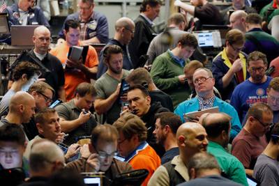 Traders work in a trading pit at the Chicago Board Options Exchange, Monday, Dec. 11, 2017, in Chicago, as they trade S&P 500 options, unrelated to bitcoin futures. Trading in bitcoin futures began Sunday on the CBOE. (AP Photo/Kiichiro Sato)