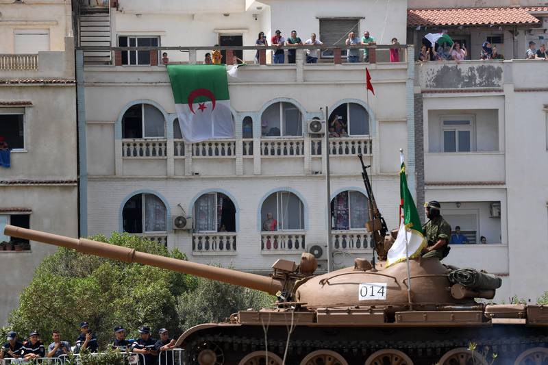 An Algerian tank drives through a street in the capital Algiers on the country's independence day.  AFP