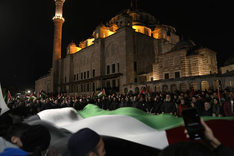 A large Palestinian flag is unfurled during a protest against an Israeli police raid of Al Aqsa Mosque compound in Jerusalem's Old City. AP 