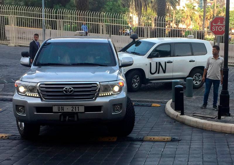 FILE - In this Saturday, April 14, 2018 file photo, UN vehicles carrying the team of the Organization for the Prohibition of Chemical Weapons (OPCW), arrive at hotel hours after the U.S., France and Britian launched an attack on Syrian facilities for suspected chemical attack against civilians, in Damascus, Syria. The OPCW has been thrust once again into the international limelight by a nerve agent attack on a former Russian spy in Britain and allegations of a chemical bombardment on the Syrian city of Douma. It is now attempting to investigate, but its experts have not yet been able to visit the scene. (AP Photo/Bassem Mroue, File)