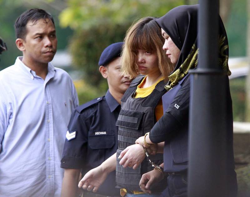 Vietnamese suspect Doan Thi Huong, wearing a bulletproof vest, is escorted by police officers out of court in Sepang, Malaysia, after being formally charged with the murder of Kim Jong-nam. Daniel Chan / AP Photo