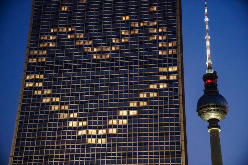 Windows of the Park Inn hotel at the Alexanderplatz square are lit in the shape of a heart, next to the TV tower in Berlin, Germany.  EPA