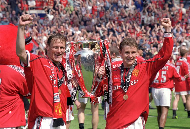 Manchester United's Teddy Sheringham and Ole Gunnar Solskjaer lift the Premier League trophy after winning the title in the 1999-2000 season with 91 points. Allsport