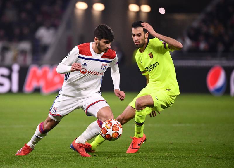 Lyon's Martin Terrier vies for the ball with Barcelona's Sergio Busquets. AFP