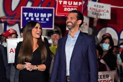 Donald Trump Jr., right, smiles along with his girlfriend Kimberly Guilfoyle prior to a news conference at Georgia Republican Party headquarters  in Atlanta. AP Photo