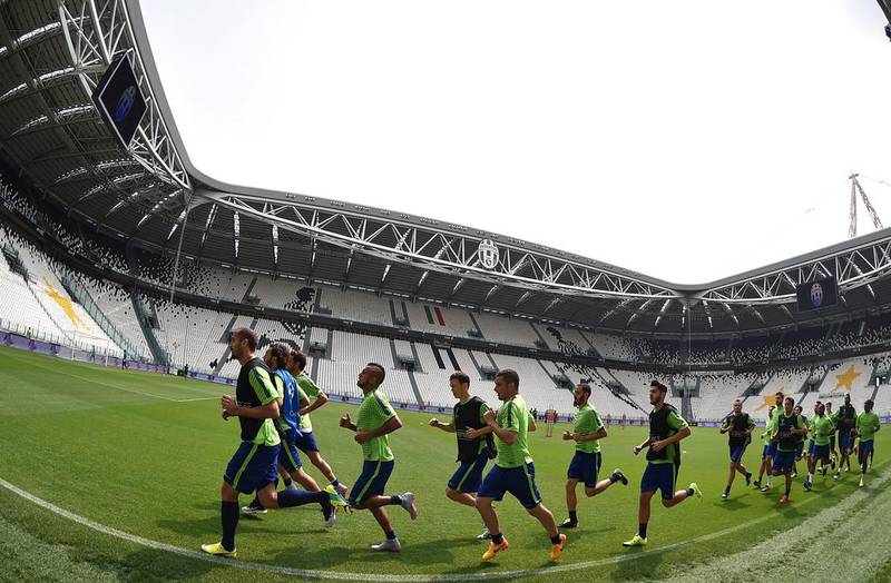 Juventus players warm up during a training session for media on Monday in Turin ahead of the Champions League final. Vlaerio Pennecino / Getty Images