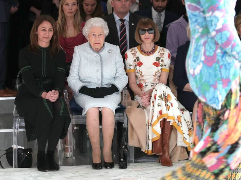 Queen Elizabeth sits next to editor-in-chief of 'Vogue' Anna Wintour as she visits London Fashion Week in 2018. Getty Images