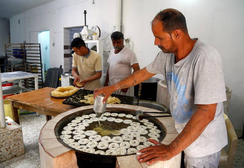 Workers prepare traditional sweets for sale during Ramadan at a shop in Najaf, Iraq.  Reuters