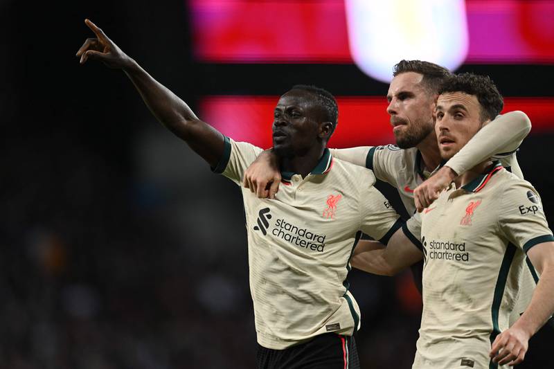 Liverpool's Senegalese striker Sadio Mane celebrates with    Jordan Henderson and Diogo Jota. AFP