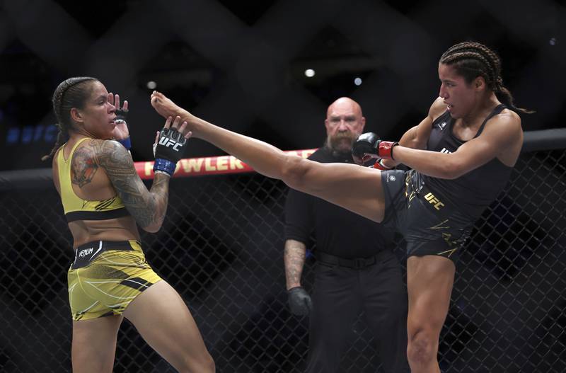 Amanda Nunes avoids a kick from Julianna Pena during their bantamweight title bout at UFC 277. AP