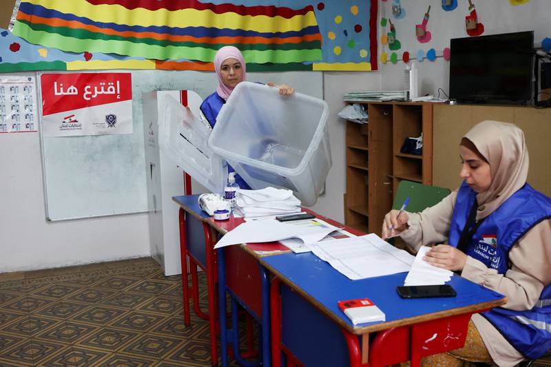 An electoral worker shows an empty ballot box at a polling station in Beirut. Reuters
