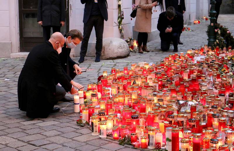President of the European Council Charles Michel with Austrian Chancellor Sebastian Kurz, right, place candle  tributes to those killed, as they commemorate the terror attack one week ago in Vienna, Austria, Monday, Nov. 9, 2020. Several shots were fired shortly after 8 p.m. local time on Monday, Nov. 2, in a lively street in the city center of Vienna. (AP Photo/Ronald Zak)