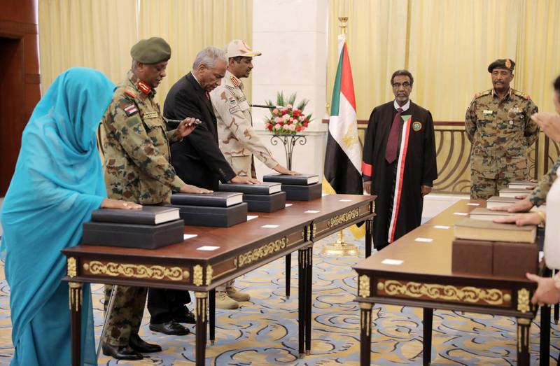 Leader of Sudan's transitional council, Lieutenant General Abdel Fattah Al-Abdelrahman Burhan looks on as military and civilian members of Sudan's new ruling body, the Sovereign Council, are sworn in at the presidential palace in Khartoum, Sudan. Reuters