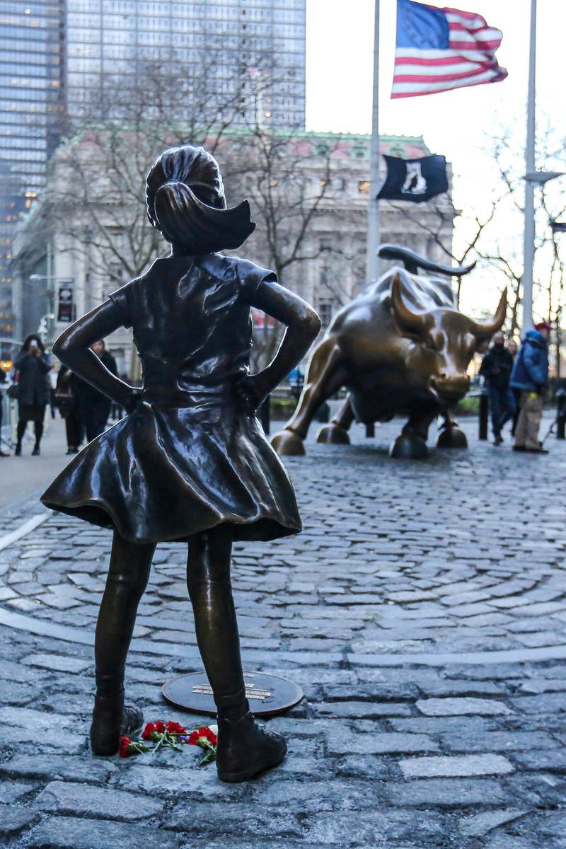 NEW YORK, NY - MARCH 9: Hundreds of tourists take photos of 'The Fearless Girl' statue as it stands across from the Wall Street's famous Charging Bull to draw attention to the gender equality and lack of female managers on March 09, 2017 in New York City, US. Third largest asset manager worldwide State Street Global Advisors installed the statue on March 08, 2017. (Photo by William Volcov/Brazil Photo Press/LatinContent/Getty Images) *** Local Caption ***  bz28mr-fearless-girl.jpg