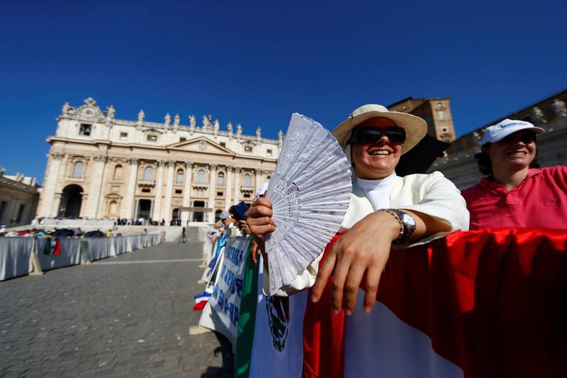 People brave heat to attend the general audience in St Peter's Square, at the Vatican.  Reuters