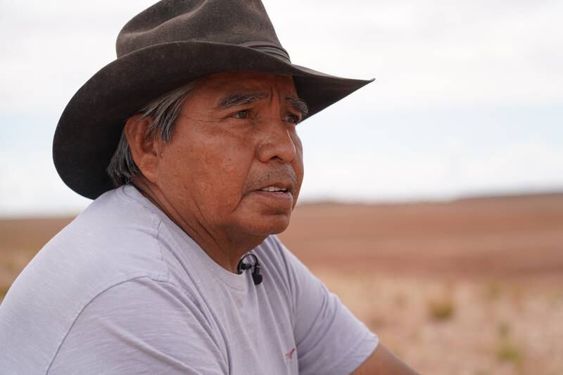 Franklin Martin, a Navajo rancher, looks out at dry a earth dam in the Bodaway area of the Navajo Nation reservation.