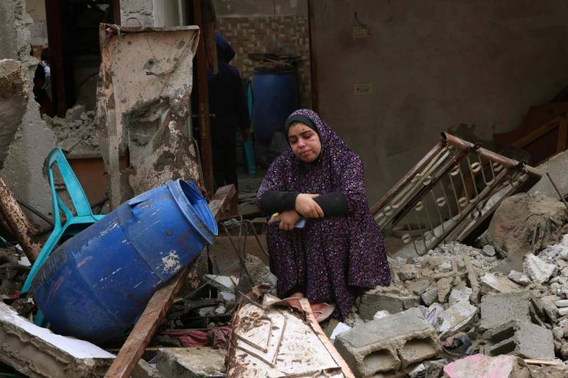 A woman sits in the rubble of southern Gaza. AFP