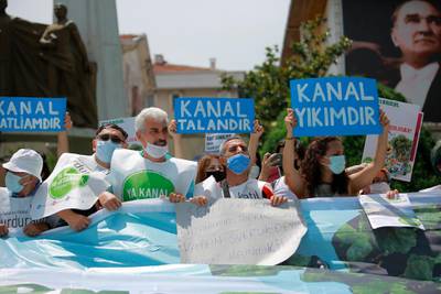 Demonstrators in Istanbul hold a placard that reads '"Canal is destructıon' during a protest in Istanbul, on Saturday, June 26, 2021. AP Photo