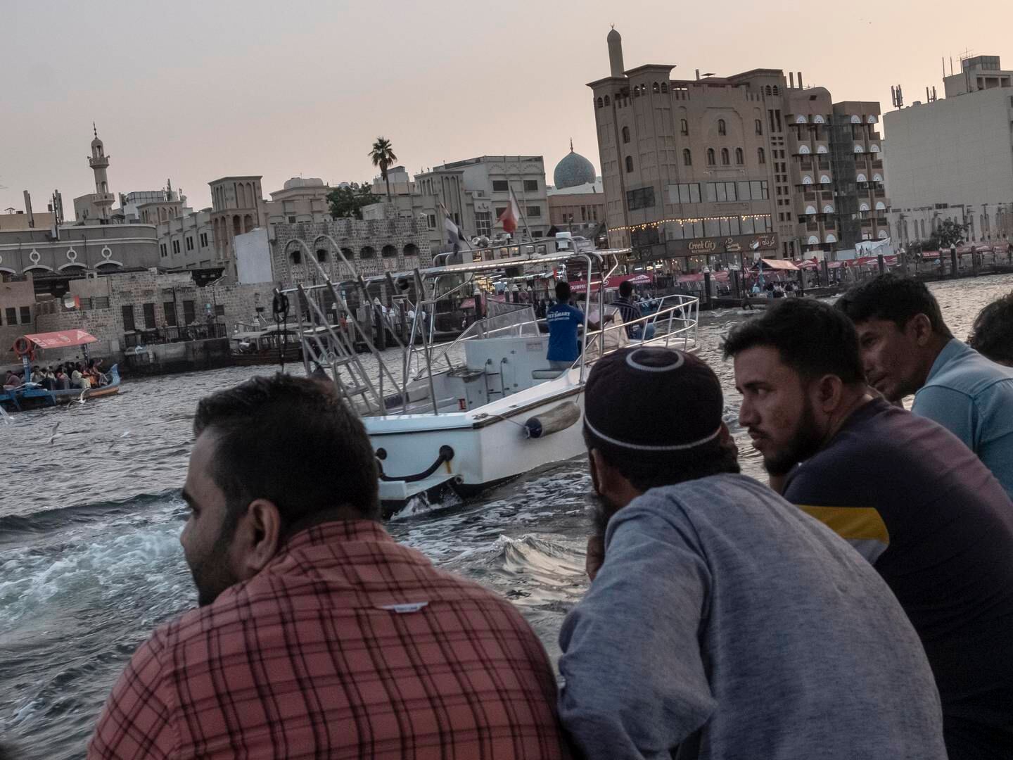 Onlookers watching the hustle and bustle on Dubai Creek. Antonie Robertson / The National
