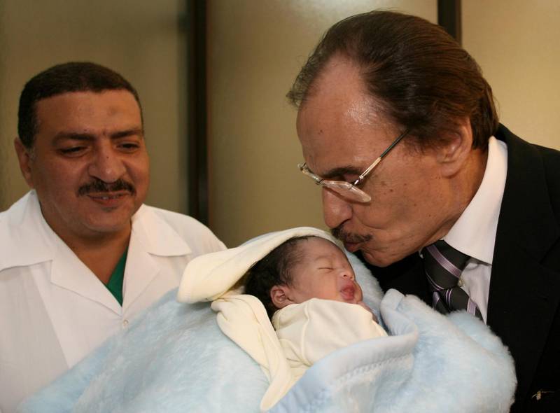 Egyptian actor Ezzat al-Alayli kisses a five-day-old child during his visit to a hospital in Beirut 08 August 2006. Alayli arrived in the Lebanese capital with a delegation headed by Secretary General of Egypt's National Democratic Party Gamal Mubarak in support of the Lebanese people. Israel's massive offensive launched on July 12 has killed more than 1,000 people in Lebanon, wounded more than 3,000 and driven more than 915,000 -- close to a quarter of the population -- from their homes.          AFP PHOTO/Anwar AMRO (Photo by ANWAR AMRO / AFP)