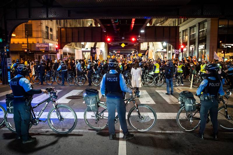 Chicago police officers keep watch as at least 1,000 protesters march through the Loop to demand every vote be counted in the general election, in Chicago, as President Donald Trump tries to stop the effort in key battleground states. AP