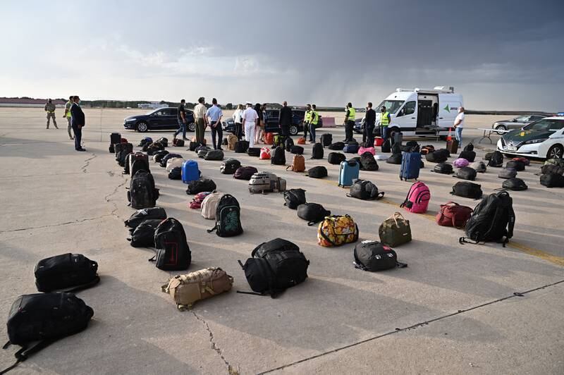 Spanish military staff inspect luggage of some of the 260 Afghan citizens who were flown by Spanish authorities to the Torrejon military base. EPA