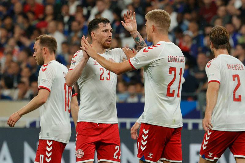 Denmark's forward Andreas Cornelius (2R) celebrates with Denmark's midfielder Pierre-Emile Hojbjerg (2L)  after scoring his team's second goal  during the UEFA Nations League - League A Group 1 first leg football match between France and Denmark at the Stade de France in Saint-Denis, north of Paris, on June 3, 2022.  (Photo by Geoffroy VAN DER HASSELT  /  AFP)