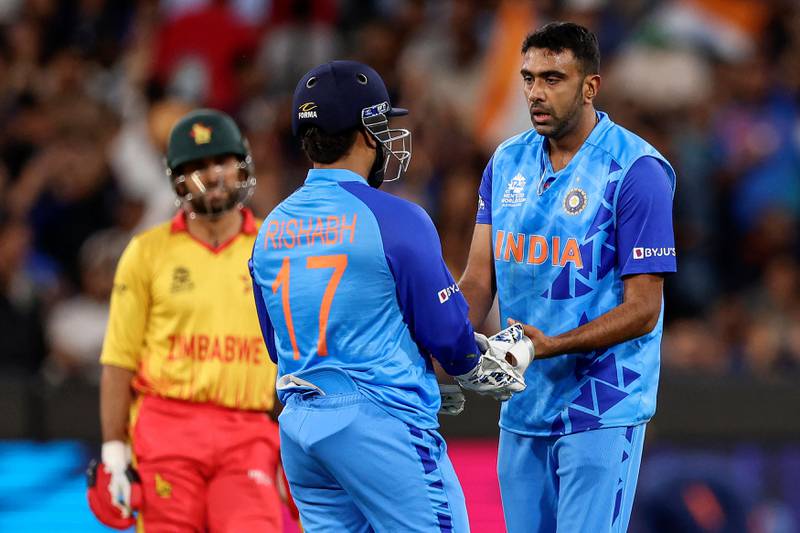 India's Ravichandran Ashwin, right, celebrates the wicket of Zimbabwe's Ryan Burl. AFP
