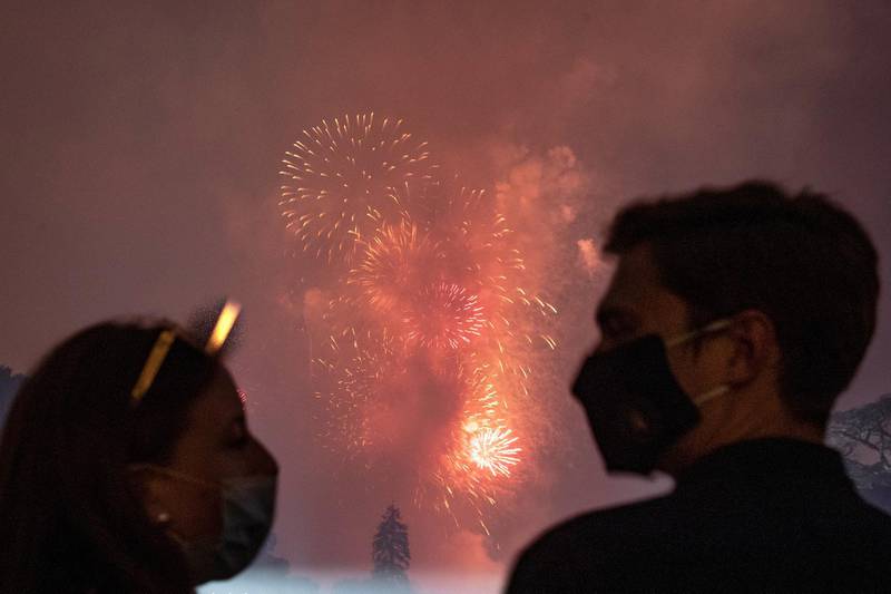 Guests wearing protective face masks watch the fireworks display from the South Lawn of the White House as they celebrate US Independence Day. Reuters
