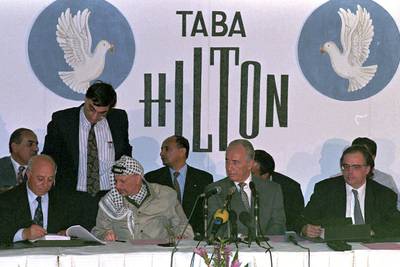 PLO chairman Yasser Arafat and Israeli foreign minister Shimon Peres at the Hilton hotel in Taba, Egypt, September 1995. AP Photo