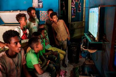 Children play video games in a shop in Dansha, Ethiopia, on November 25, 2020. / AFP / EDUARDO SOTERAS
