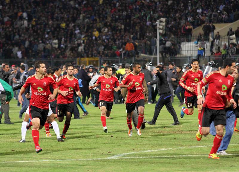 Al Ahly players run for safety during their match on February 1, 2012, in Port Said, where riots turned the game into one of Egypt's most violent footballing episodes. Ahmed Hassan / AP