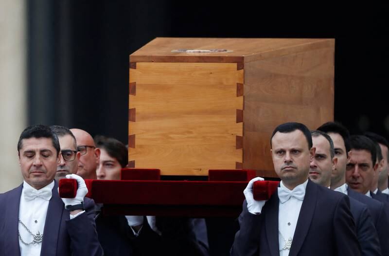 The former pontiff's coffin is brought into St Peter's Square. Reuters