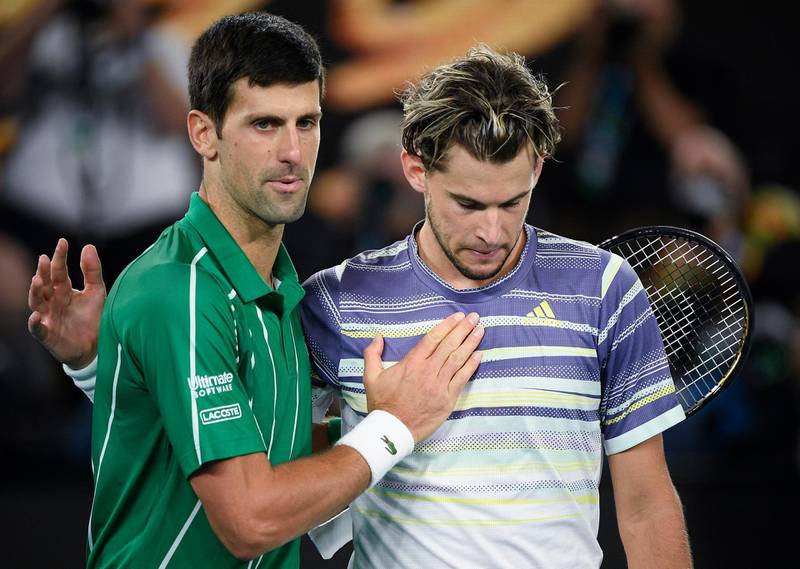 Novak Djokovic commiserates Dominic Thiem after the match. AP