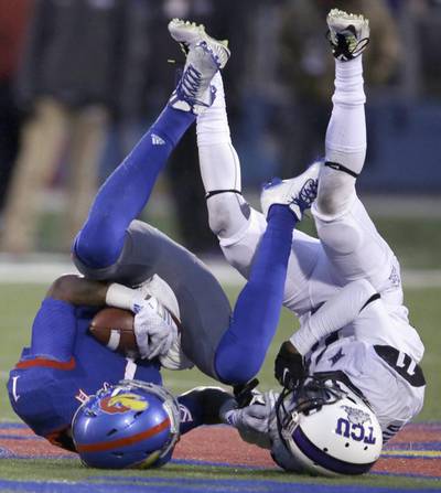 Kansas wide receiver Rodriguez Coleman (1) is tackled by TCU cornerback Ranthony Texada (11) during the second half of an NCAA college football game in Lawrence, Kansas. Orlin Wagner / AP 