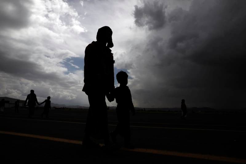 People walk at Sana'a Airport during a prisoner swap on April 14, 2023. EPA